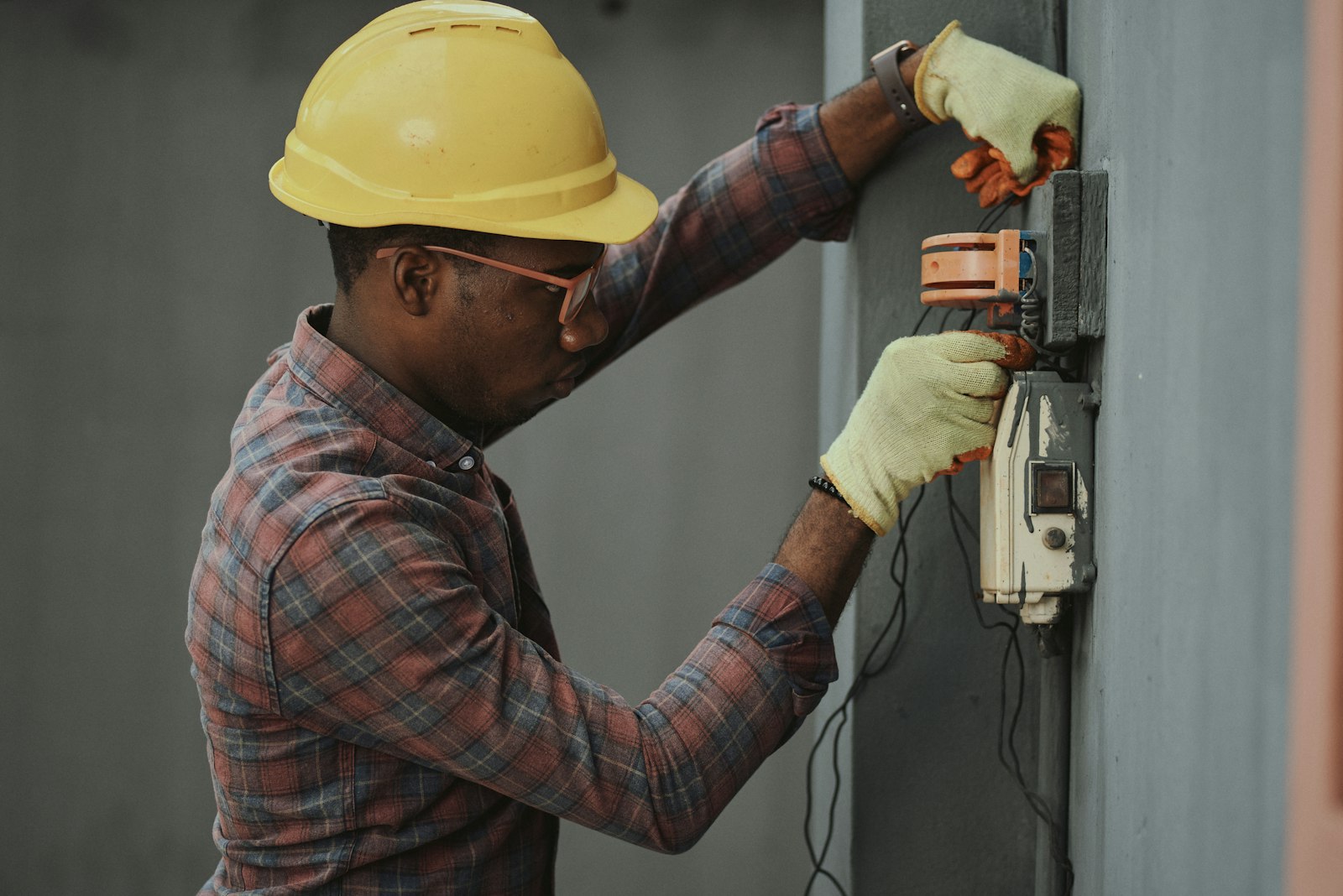 Electrician wiring a service box on site