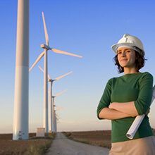 Engineer Stands In Front of Wind Turbines