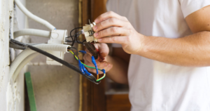 An electrician is working with wires.