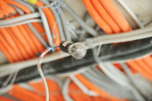 A lightbulb is pictured among other electrical wires.