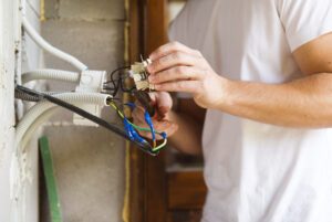 An electrician is working with wires.